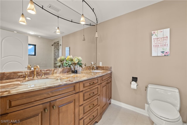 bathroom with tile patterned floors, vanity, and toilet