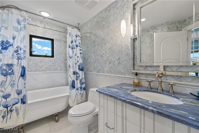 full bathroom featuring vanity, shower / bathtub combination with curtain, tile walls, tile patterned flooring, and toilet