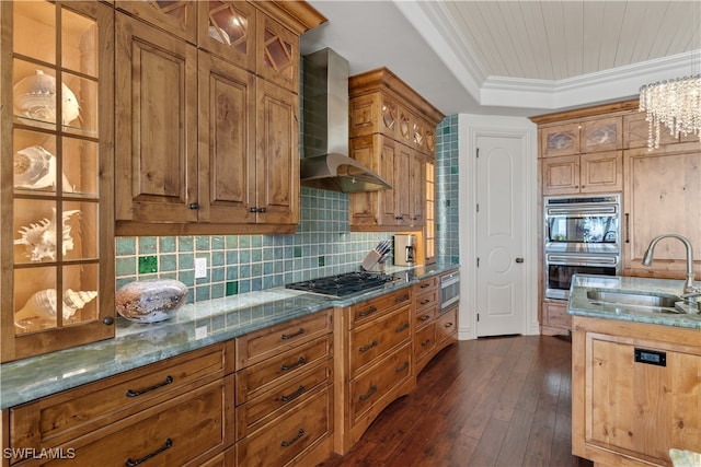 kitchen with ornamental molding, wall chimney exhaust hood, stainless steel appliances, sink, and dark hardwood / wood-style floors