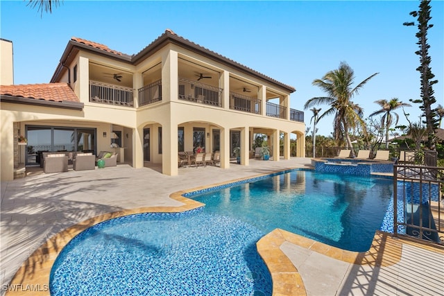 view of pool featuring a patio area, ceiling fan, and an in ground hot tub