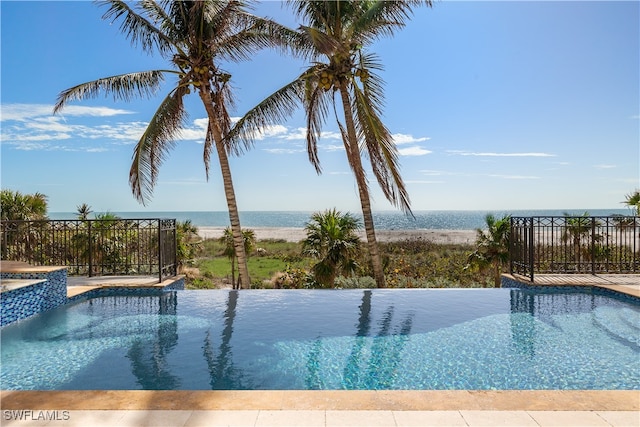 view of swimming pool featuring a water view