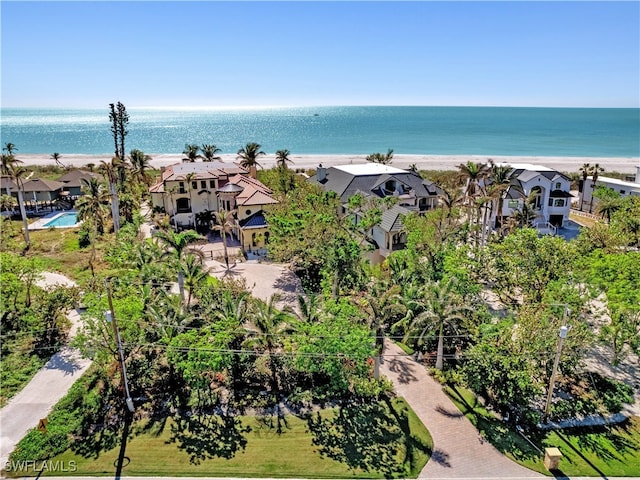 drone / aerial view featuring a water view and a view of the beach