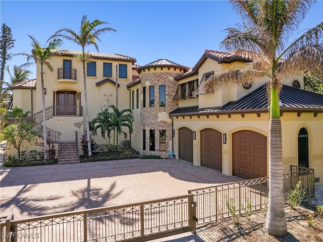 mediterranean / spanish house with a garage