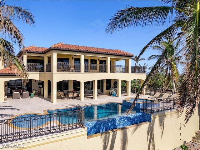 view of swimming pool with pool water feature, an outdoor hangout area, an in ground hot tub, and a patio