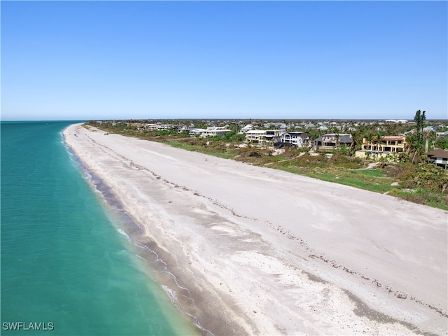 bird's eye view featuring a view of the beach and a water view