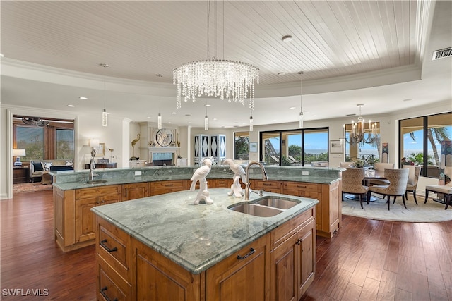 kitchen with decorative light fixtures, a spacious island, plenty of natural light, and sink