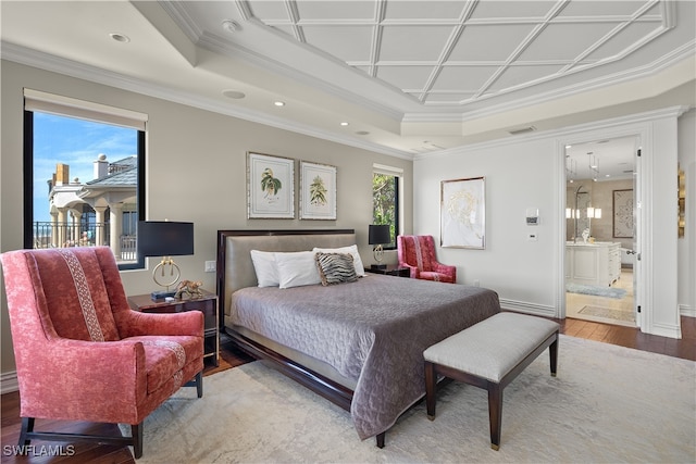 bedroom featuring ensuite bath, hardwood / wood-style floors, coffered ceiling, and ornamental molding