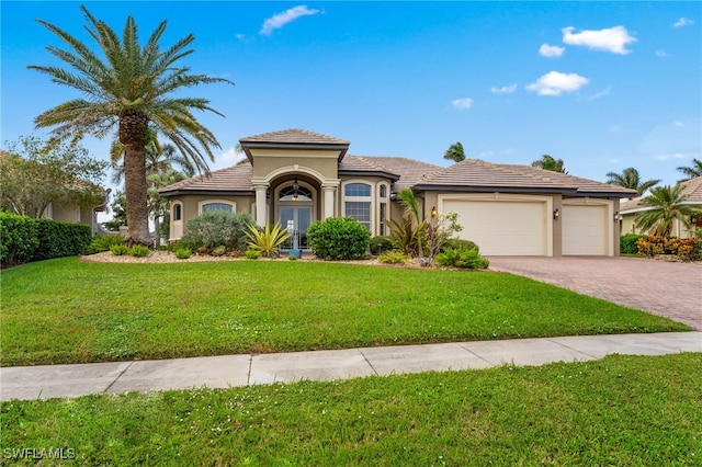 mediterranean / spanish-style house with a front yard and a garage