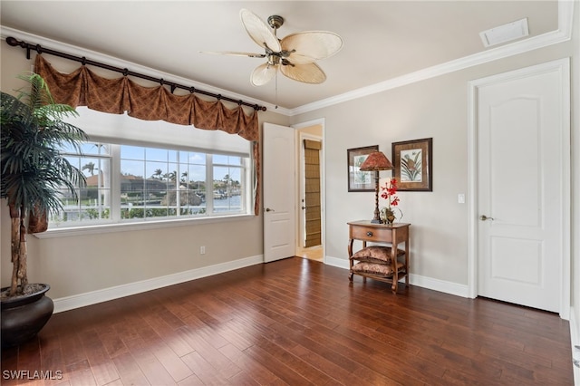 foyer entrance with ceiling fan, dark hardwood / wood-style flooring, and ornamental molding