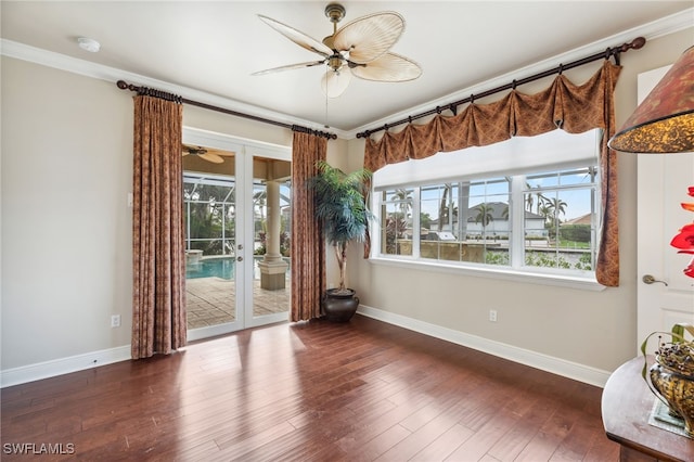 unfurnished room featuring dark hardwood / wood-style floors, ceiling fan, crown molding, and french doors