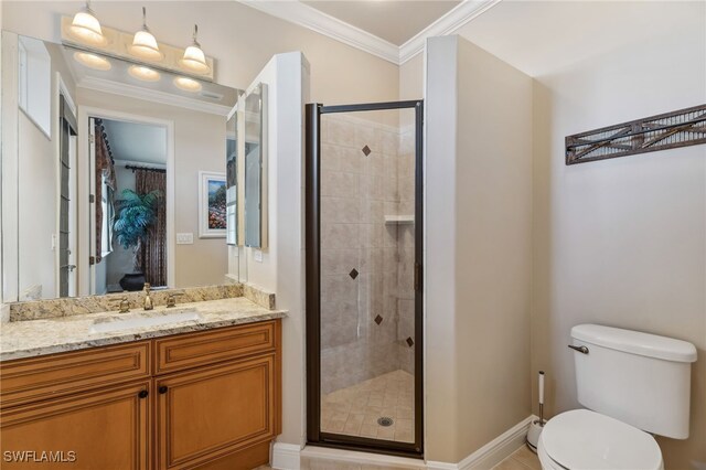 bathroom featuring a shower with door, vanity, ornamental molding, and toilet