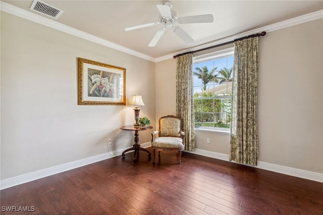 living area featuring ceiling fan, crown molding, and dark wood-type flooring