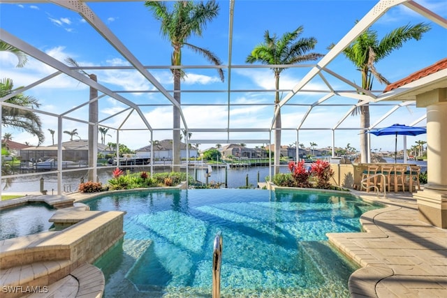 view of pool with a lanai, a water view, an outdoor bar, and a patio