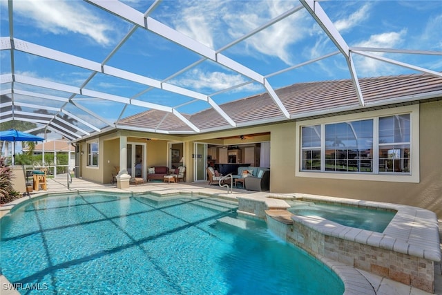 view of swimming pool with an in ground hot tub, an outdoor hangout area, ceiling fan, glass enclosure, and a patio