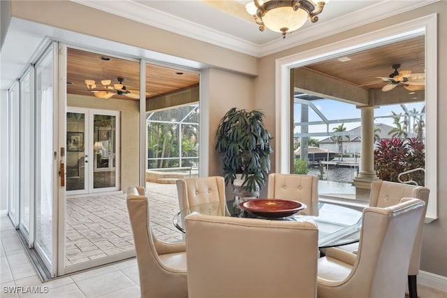 tiled dining space featuring ceiling fan, a wealth of natural light, crown molding, and wood ceiling