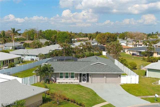 view of front of house with a lanai, a front lawn, and a garage