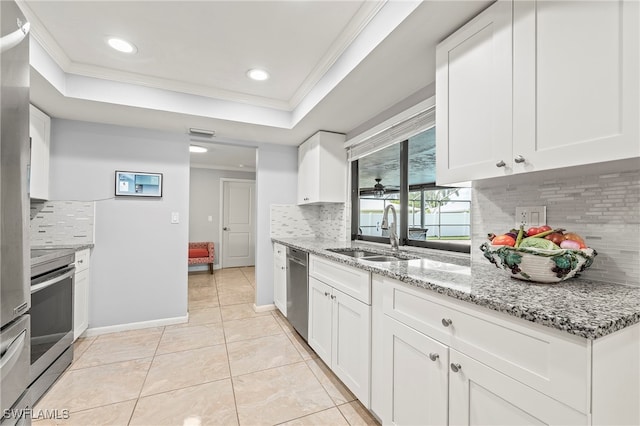 kitchen with white cabinets, backsplash, and sink