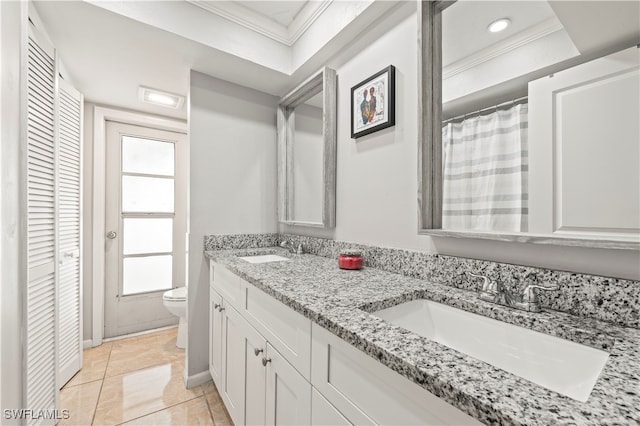 bathroom featuring tile patterned floors, vanity, ornamental molding, and toilet