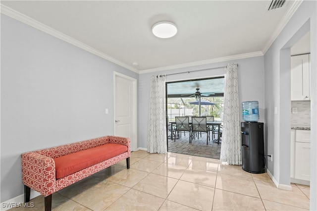 living area featuring crown molding, light tile patterned floors, and ceiling fan