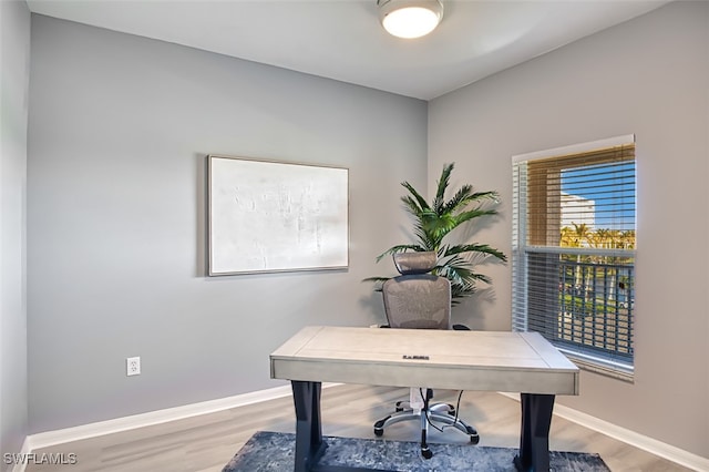 office space with wood-type flooring