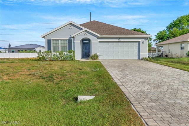 ranch-style house featuring a garage and a front lawn