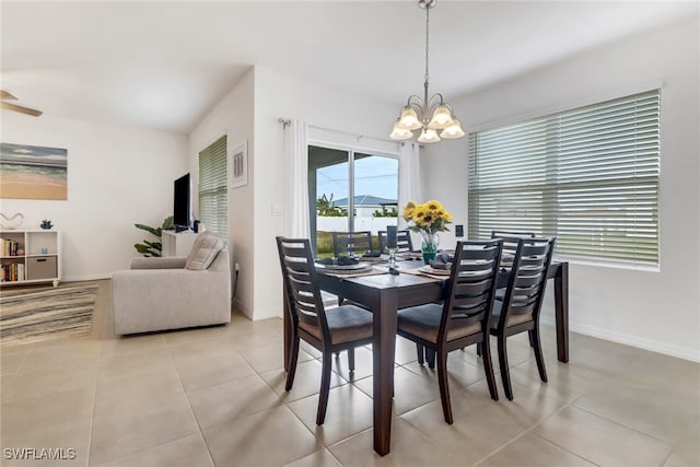 dining room with light tile patterned floors and a chandelier