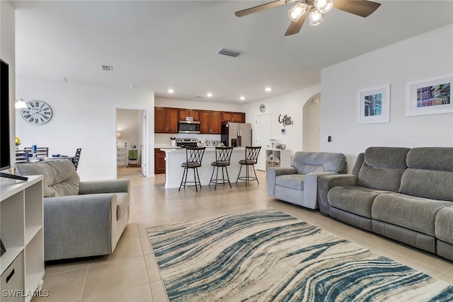 living room with ceiling fan and light tile patterned flooring