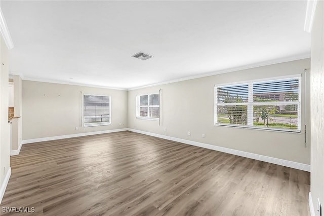 unfurnished room featuring crown molding and dark wood-type flooring