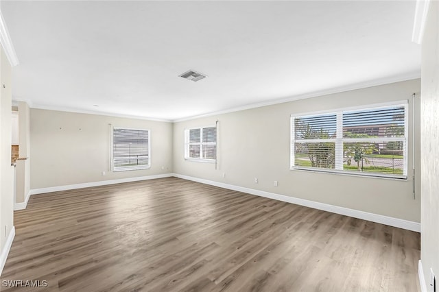 2199 Santiago Ave, Fort Myers, FL 33905 - unfurnished room with crown molding, baseboards, wood finished floors, and healthy amount of natural light