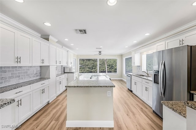 2199 Santiago Ave, Fort Myers, FL 33905 - kitchen featuring appliances with stainless steel finishes, a sink, a center island, white cabinets, and recessed lighting