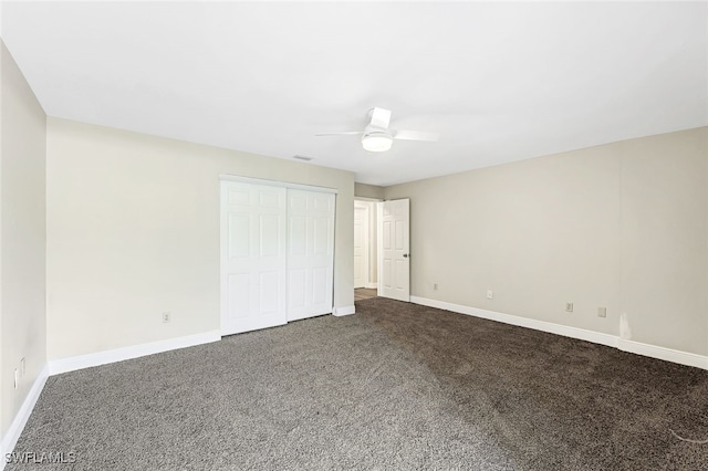 unfurnished bedroom with carpet floors, a closet, and ceiling fan