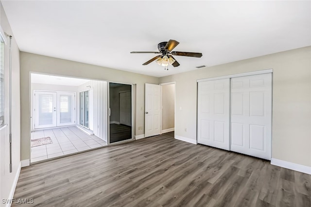 unfurnished bedroom featuring ceiling fan, a closet, and light hardwood / wood-style floors