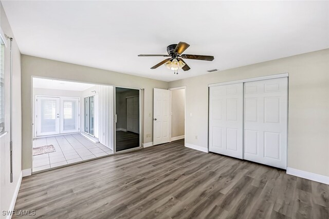 2199 Santiago Ave, Fort Myers, FL 33905 - unfurnished bedroom featuring wood finished floors, baseboards, a closet, and a ceiling fan