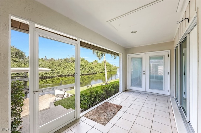 2199 Santiago Ave, Fort Myers, FL 33905 - unfurnished sunroom featuring a water view, french doors, and plenty of natural light