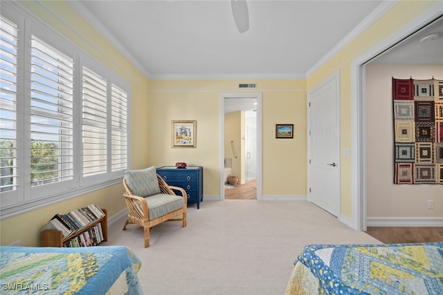 carpeted bedroom with ceiling fan and ornamental molding