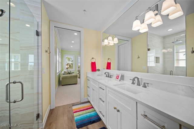 bathroom with vanity, wood-type flooring, and a shower with door