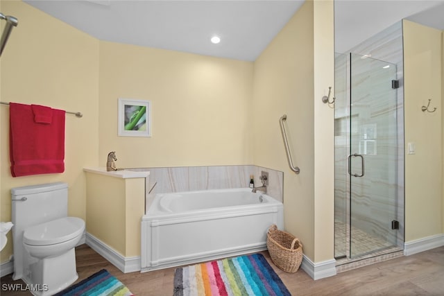 bathroom featuring plus walk in shower, hardwood / wood-style flooring, and toilet