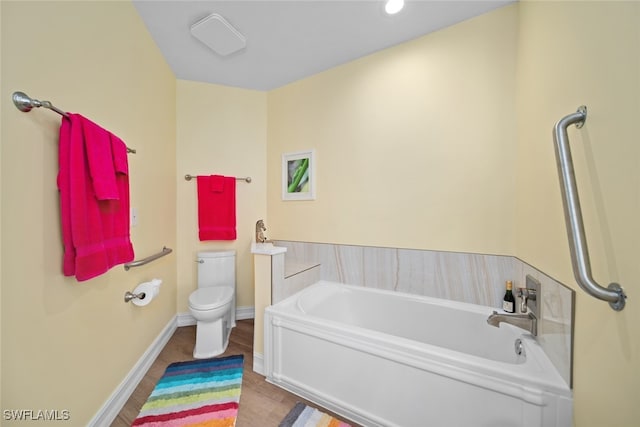 bathroom with hardwood / wood-style floors, toilet, and a tub to relax in