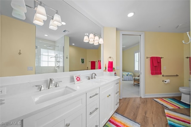 bathroom featuring vanity, hardwood / wood-style flooring, toilet, and plenty of natural light