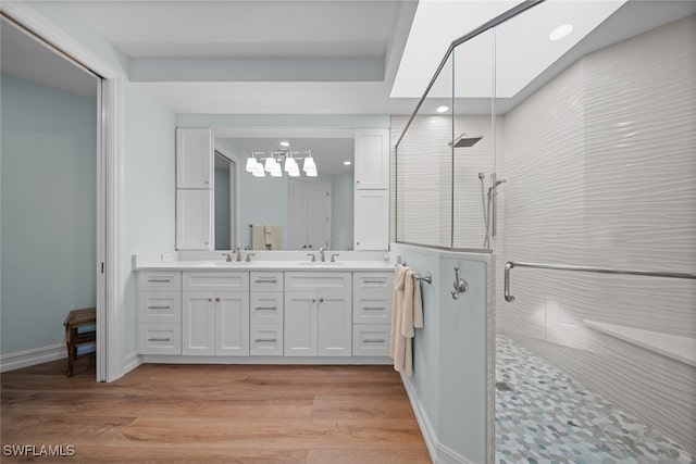 bathroom featuring vanity, wood-type flooring, and walk in shower