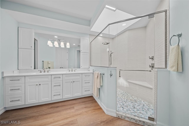 bathroom featuring hardwood / wood-style floors, vanity, and an enclosed shower