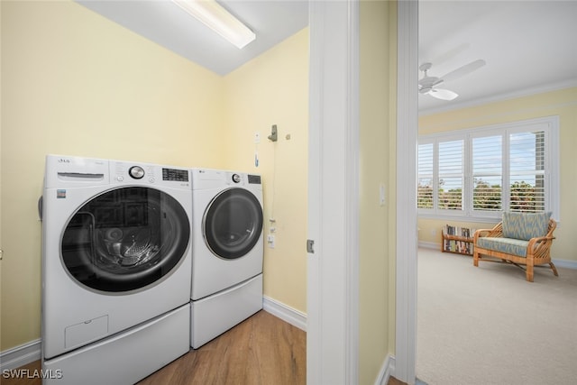 washroom with hardwood / wood-style floors, washer and dryer, ceiling fan, and crown molding