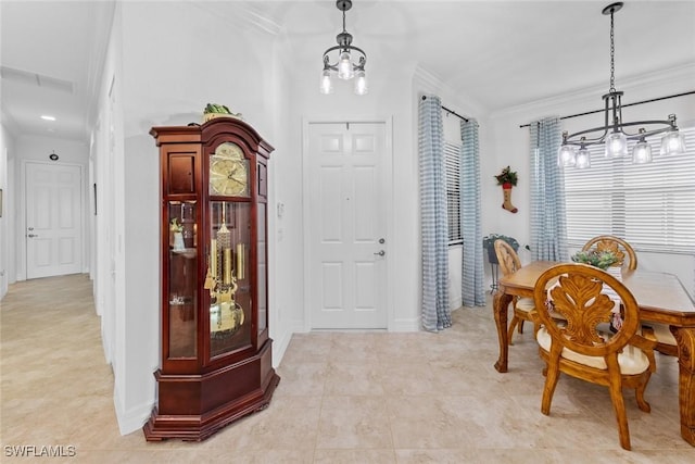 dining space featuring crown molding and an inviting chandelier