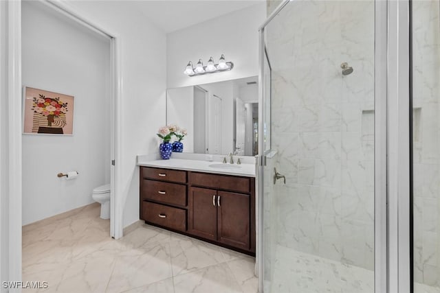 bathroom featuring a tile shower, vanity, and toilet