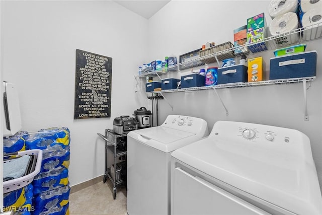 washroom with washer and clothes dryer and light tile patterned floors