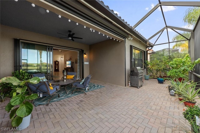 view of patio / terrace with ceiling fan, area for grilling, and a lanai