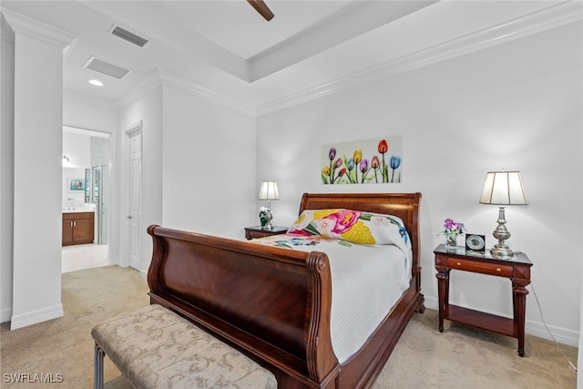 bedroom featuring ceiling fan, crown molding, light carpet, and ensuite bath