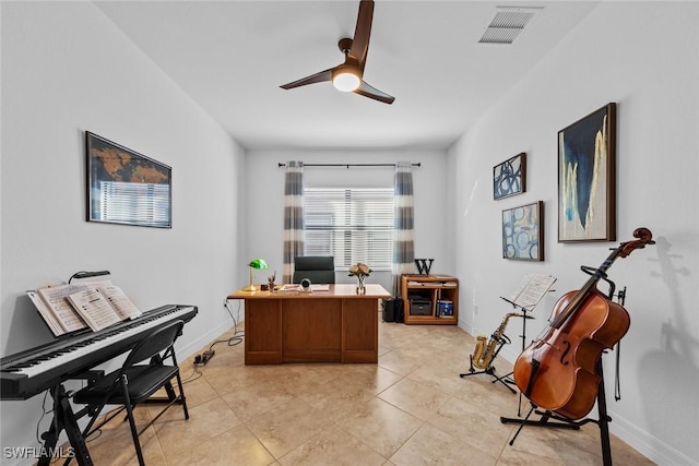 tiled office space featuring ceiling fan