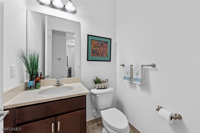 bathroom with vanity, wood-type flooring, and toilet