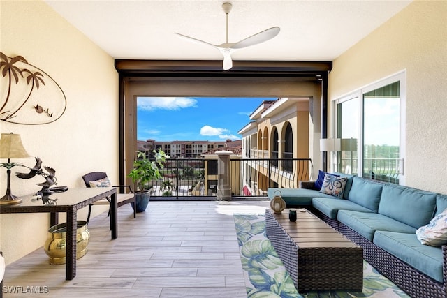 sunroom / solarium featuring ceiling fan